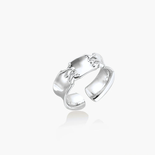 Adjustable silver-toned ring with sculptural stitch design across polished white gold-plated brass band