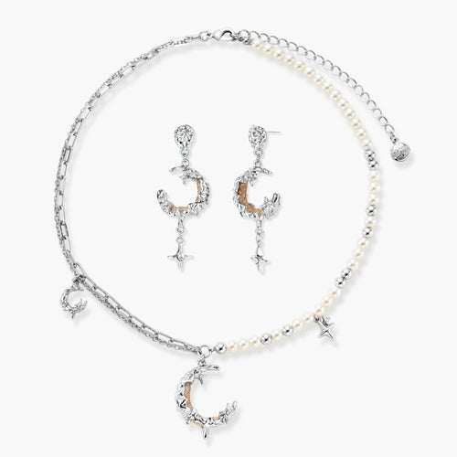 Mixed-metal jewelry set featuring layered necklaces with crescent moon pendant and pearl beads, plus matching star-drop earrings.